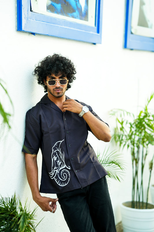 white graphic of a mammoth head on a solid black oversized shirt